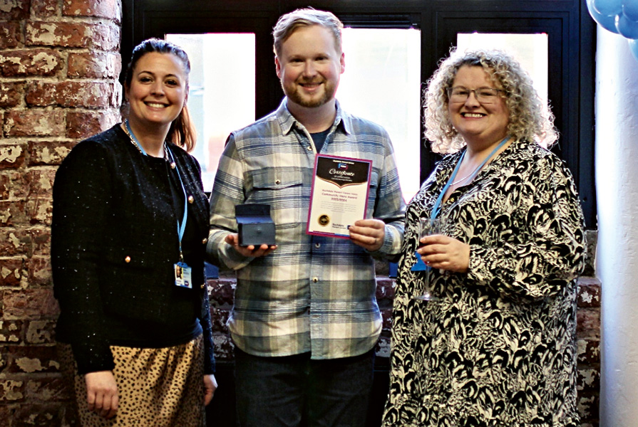 Co-chairs of Rochdale Parent Carers Voice, Katie  Berrisford (left) and Jackie Ellis (right) presenting Justin Axon, from Redwood School, with a community hero award