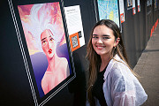 Artist Hannah Mortimer poses next to her  piece titled ‘Head in the Clouds’